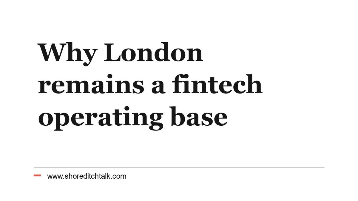 A fintech team working in a meeting room overlooking the City of London.